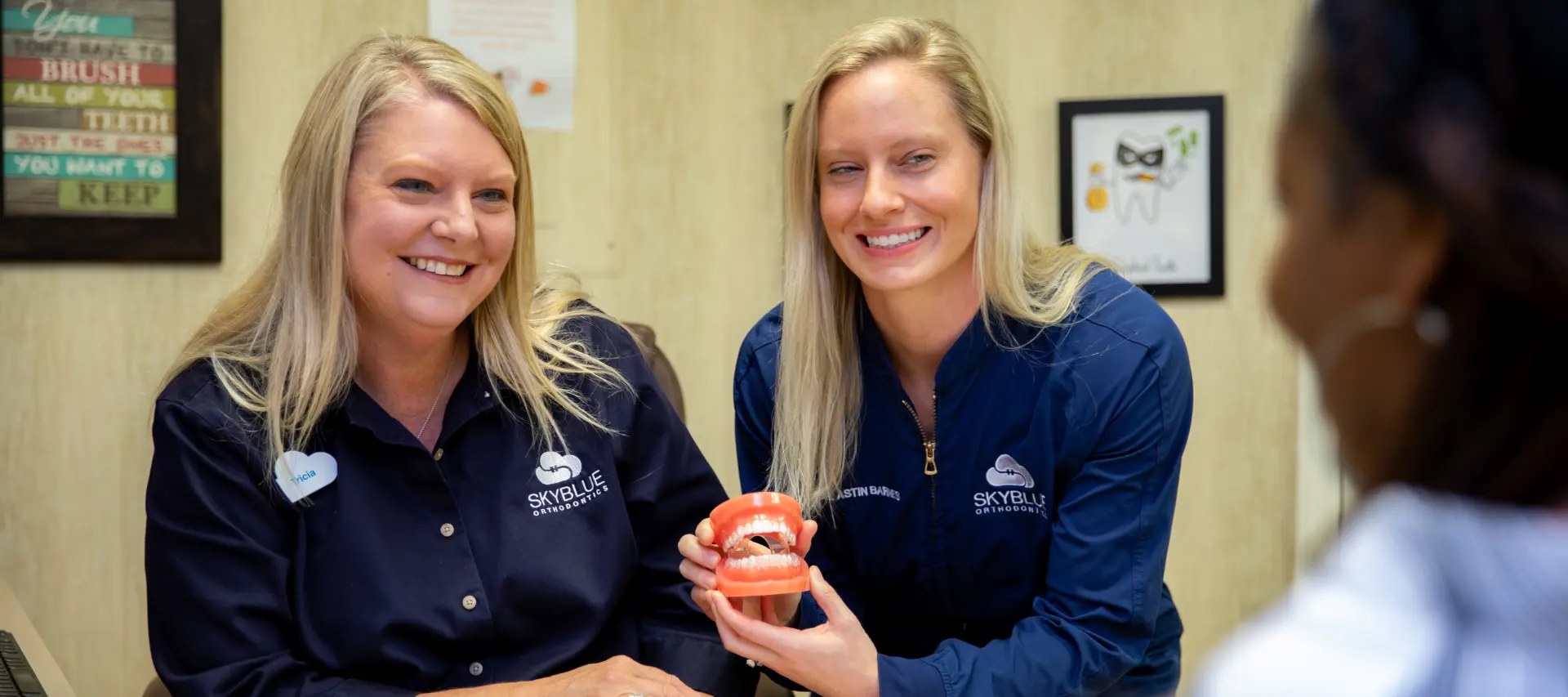 our orthodontists explaining the clear braces treatment to a patient